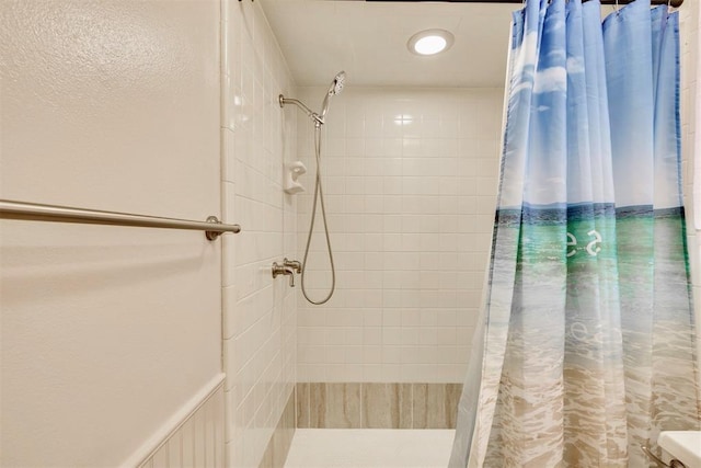 bathroom with a tile shower