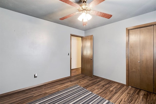 unfurnished bedroom with a closet, baseboards, ceiling fan, and wood finished floors