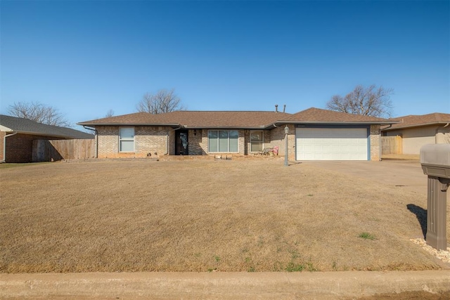 ranch-style house with concrete driveway, an attached garage, fence, and brick siding