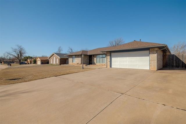 single story home with driveway, fence, a shingled roof, a garage, and brick siding