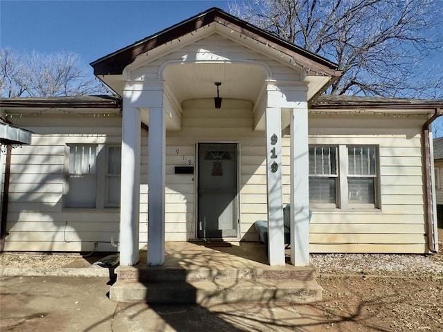 view of exterior entry featuring covered porch