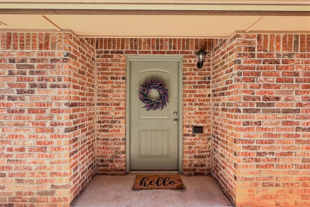 property entrance with brick siding