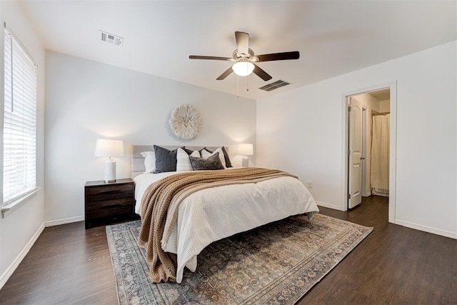 bedroom featuring dark wood finished floors, visible vents, ceiling fan, and baseboards