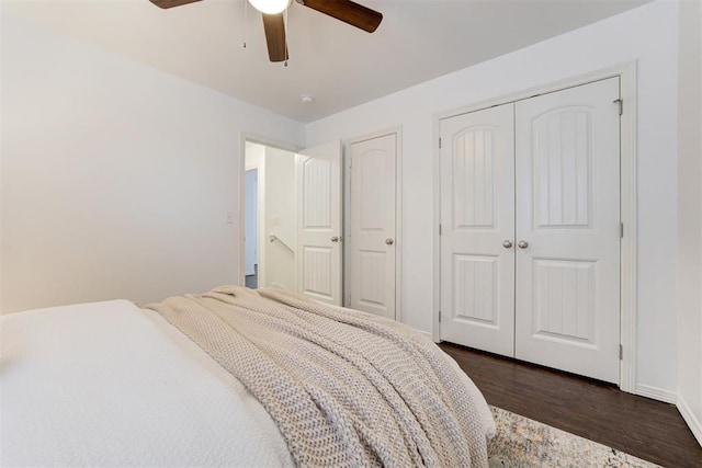 bedroom featuring dark wood-style flooring, a closet, and ceiling fan