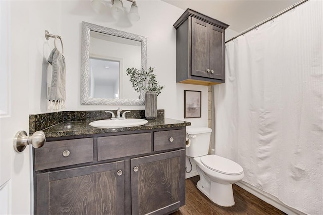 bathroom with toilet, wood finished floors, and vanity