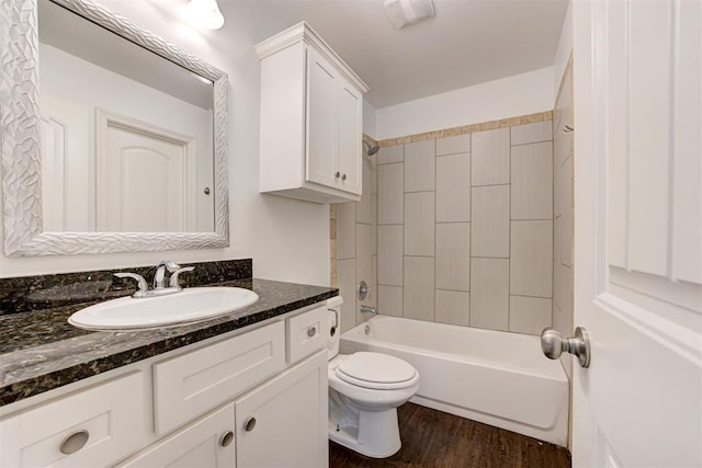 full bath with shower / bathtub combination, toilet, vanity, and wood finished floors