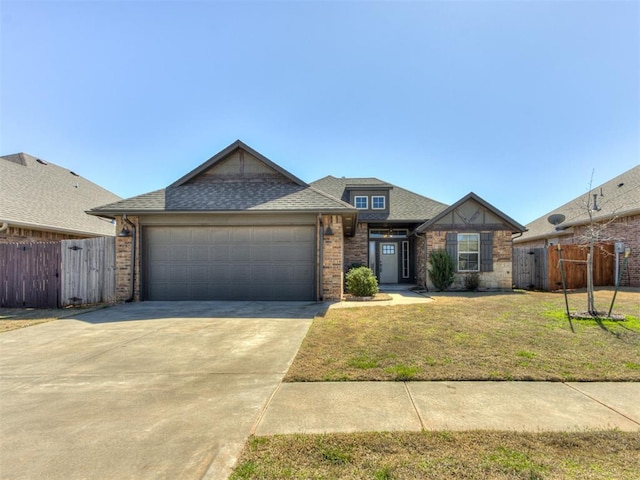 view of front of home featuring driveway, a front lawn, a garage, and fence