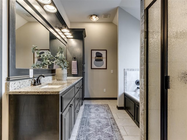 bathroom featuring tile patterned flooring, visible vents, baseboards, a bath, and vanity