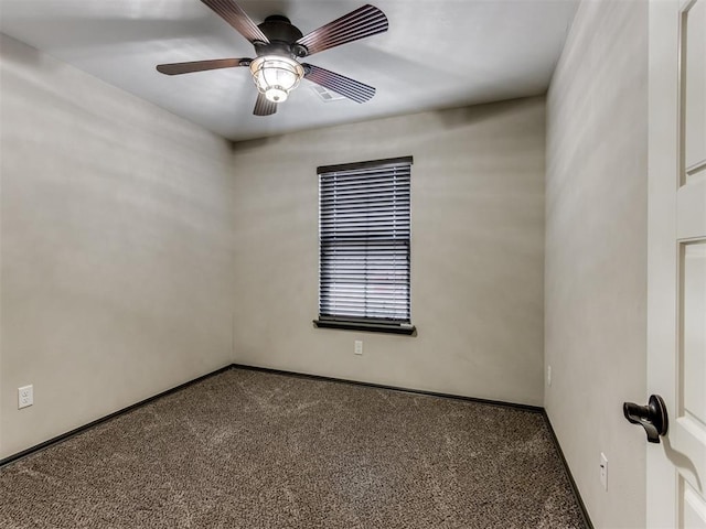 carpeted empty room with a ceiling fan and baseboards