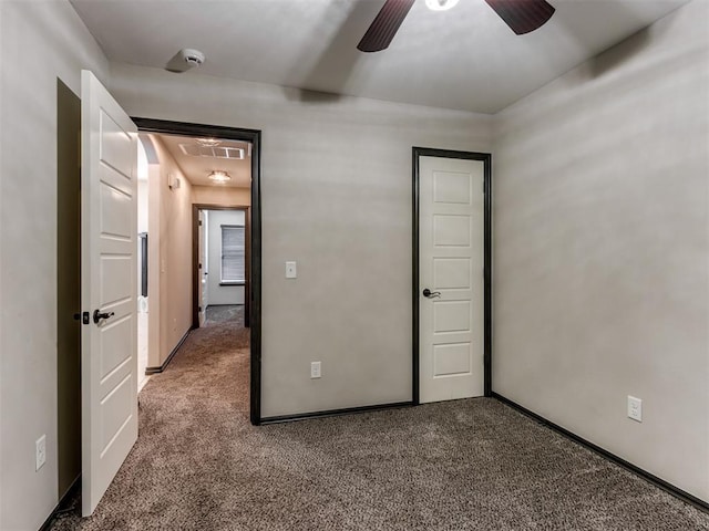 unfurnished bedroom with ceiling fan, carpet, visible vents, and baseboards