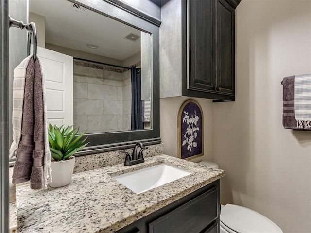 bathroom with visible vents, toilet, and vanity