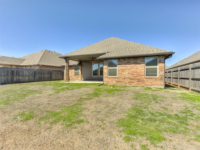 rear view of house featuring a patio, a yard, a fenced backyard, and ceiling fan