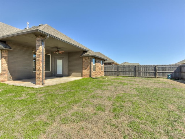 view of yard featuring a patio area, a ceiling fan, and a fenced backyard