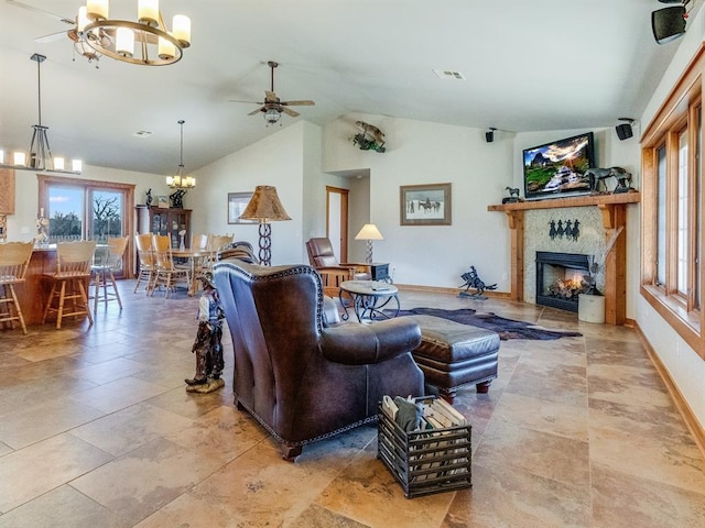 living room with visible vents, a healthy amount of sunlight, a warm lit fireplace, and baseboards