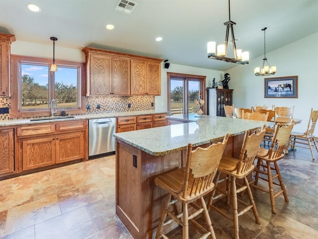 kitchen featuring a sink, visible vents, dishwasher, and decorative backsplash