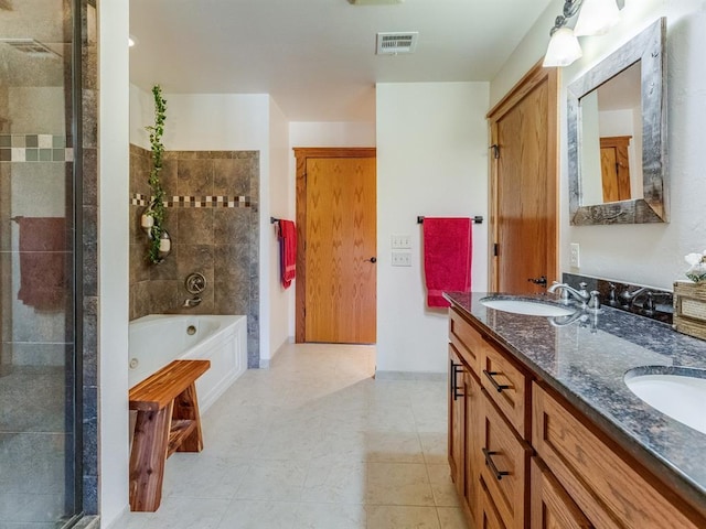 full bathroom with a sink, visible vents, a garden tub, and double vanity