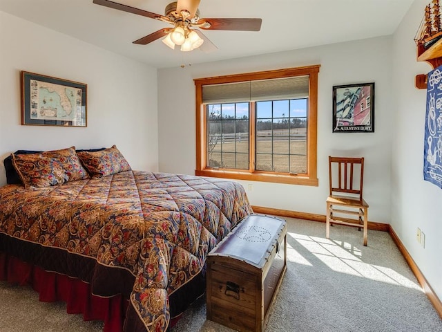 carpeted bedroom with baseboards and ceiling fan