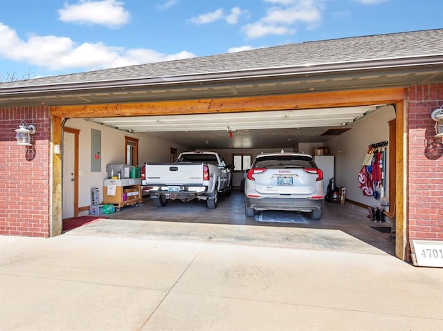 garage with electric panel and driveway