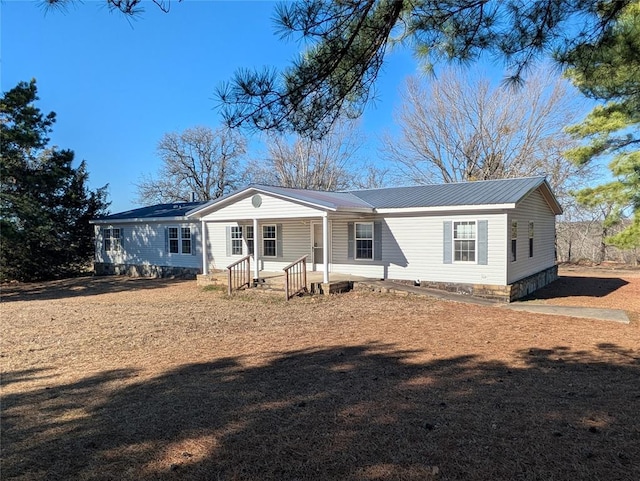 view of front of house with covered porch and metal roof