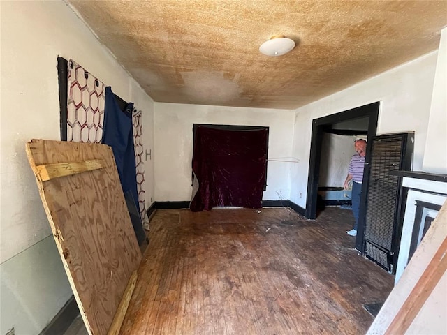 interior space featuring a fireplace, baseboards, and wood finished floors