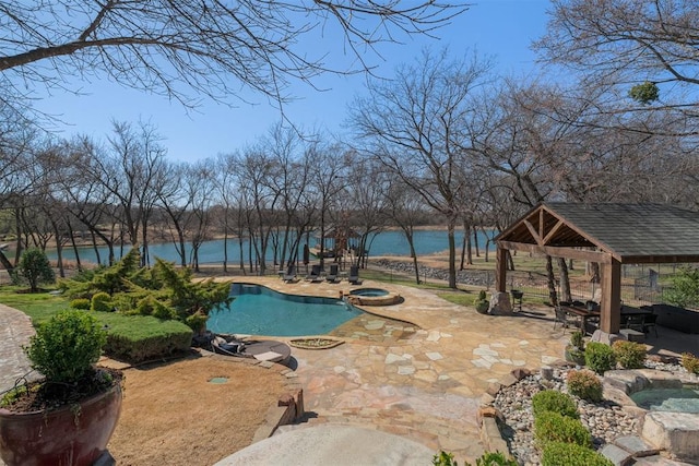 outdoor pool with a gazebo, a water view, an in ground hot tub, and a patio area