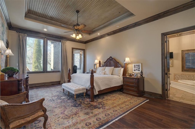 bedroom featuring a tray ceiling, crown molding, and dark wood-style flooring