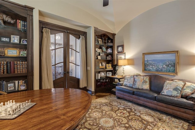 office area with built in shelves, baseboards, lofted ceiling, french doors, and a ceiling fan