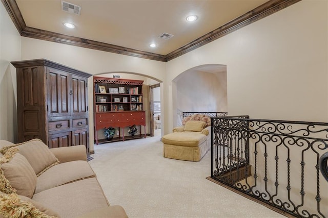 sitting room with light carpet, visible vents, recessed lighting, and crown molding