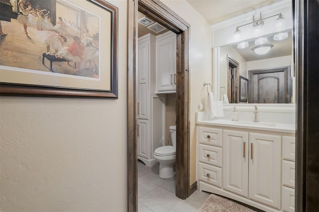 bathroom with tile patterned floors, toilet, and vanity