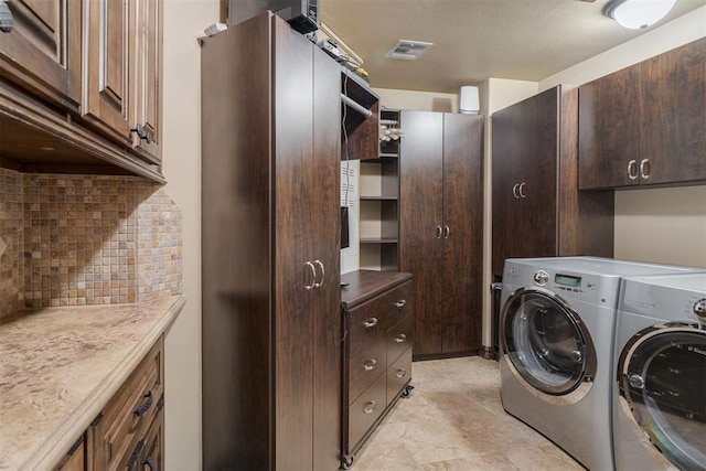 laundry area with cabinet space and separate washer and dryer