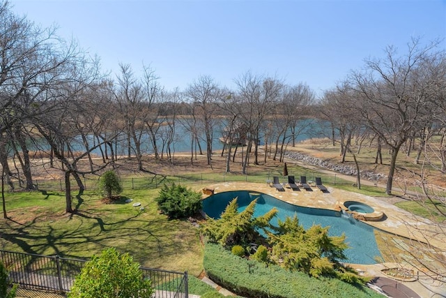 exterior space featuring a patio, a pool with connected hot tub, and fence