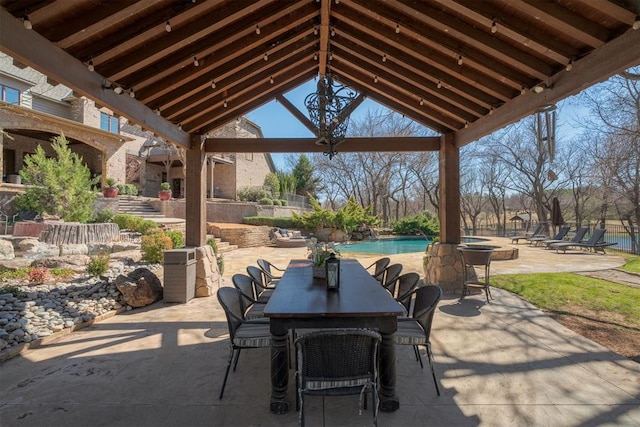 view of patio with an outdoor pool and outdoor dining space