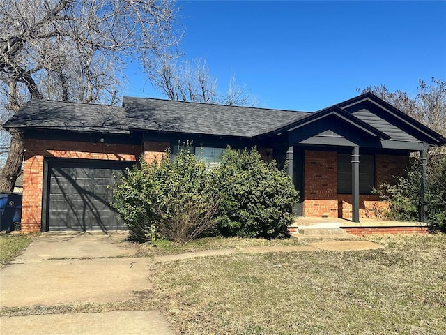 ranch-style house featuring brick siding, driveway, a garage, and roof with shingles