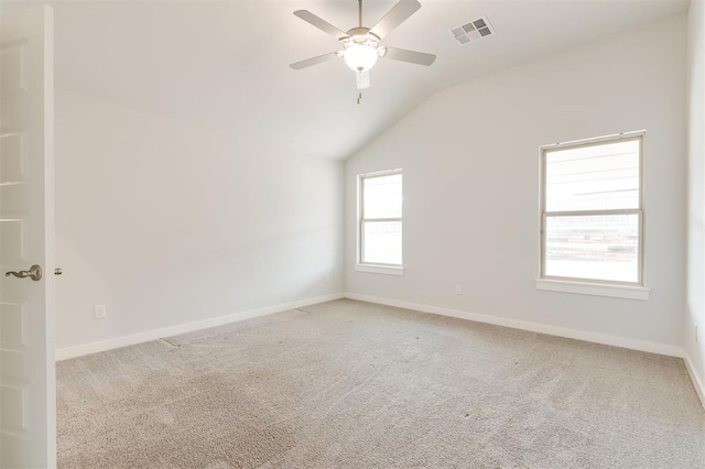 unfurnished room featuring carpet, baseboards, visible vents, ceiling fan, and vaulted ceiling