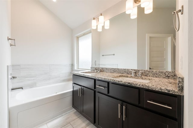 full bath featuring a bath, double vanity, lofted ceiling, and a sink