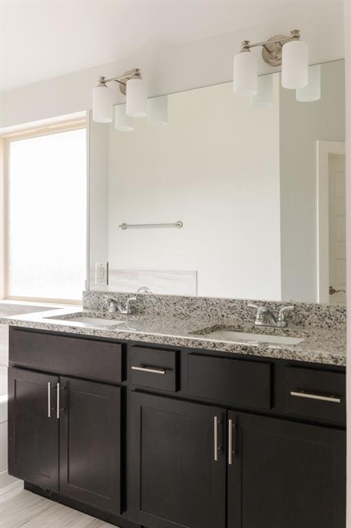 full bath featuring double vanity and a sink