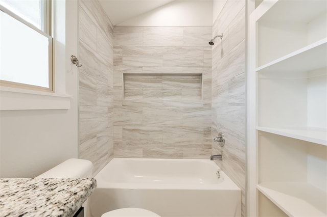 full bathroom with vanity, toilet, lofted ceiling, and bathtub / shower combination