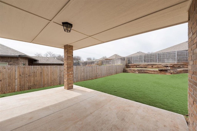 view of yard with a fenced backyard and a patio