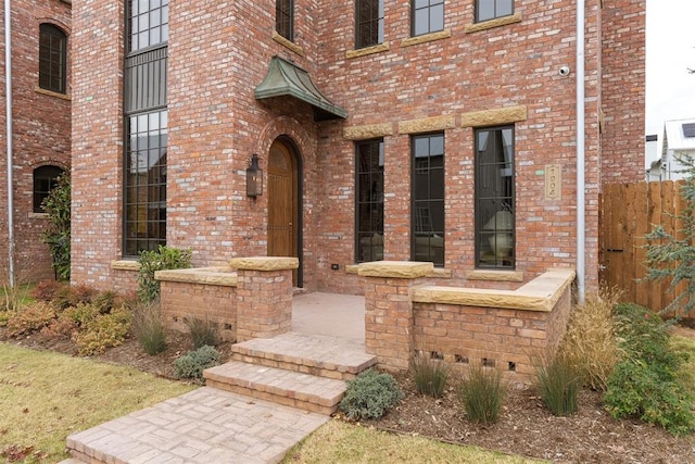 doorway to property with brick siding