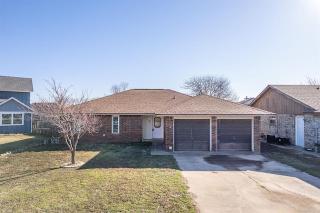 ranch-style house featuring a front lawn, roof with shingles, concrete driveway, an attached garage, and brick siding