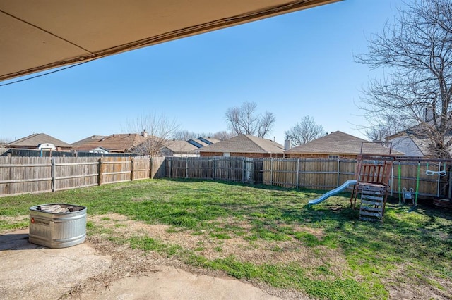 view of yard with a playground and a fenced backyard