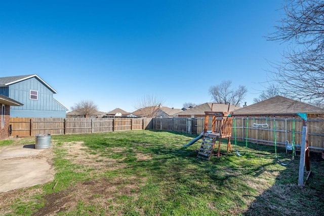 view of yard with a playground and a fenced backyard