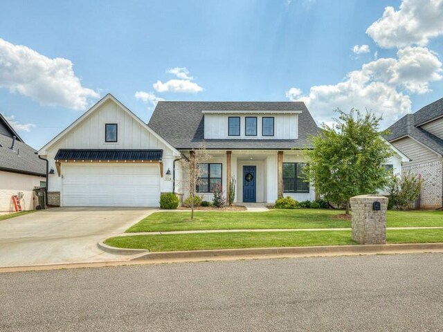 114 Alamosa Rd, Norman, OK 73069 - modern farmhouse with board and batten siding, a garage, driveway, a front lawn, and roof with shingles