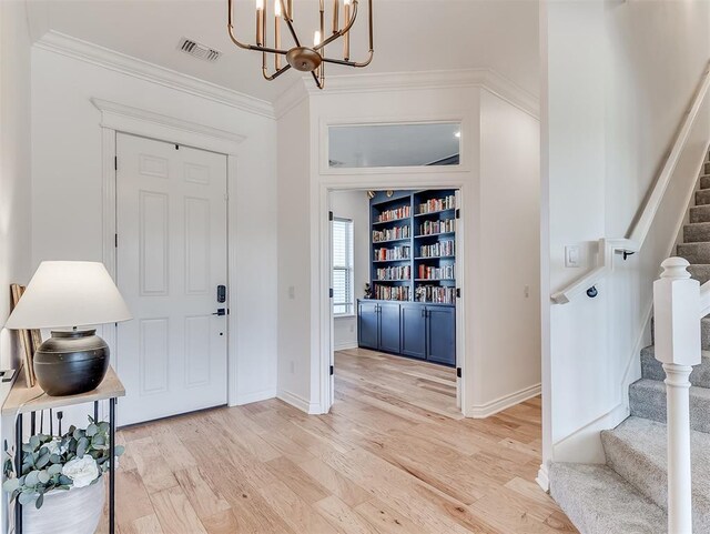 114 Alamosa Rd, Norman, OK 73069 - entrance foyer with stairs, a chandelier, crown molding, light wood-style floors, and baseboards