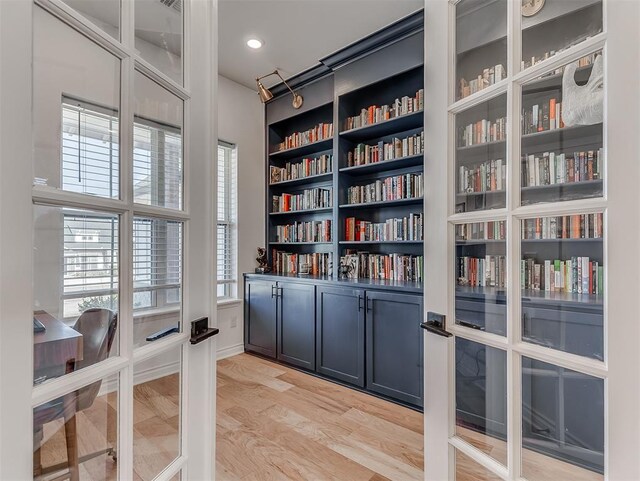 114 Alamosa Rd, Norman, OK 73069 - sitting room featuring wall of books and light wood finished floors