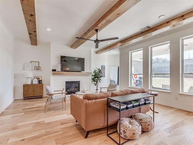 114 Alamosa Rd, Norman, OK 73069 - living room featuring beam ceiling, ceiling fan, a fireplace, light wood-type flooring, and baseboards