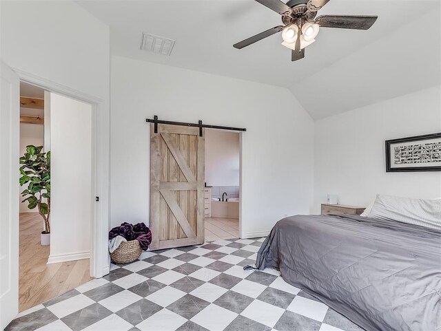 114 Alamosa Rd, Norman, OK 73069 - bedroom featuring a barn door, baseboards, vaulted ceiling, connected bathroom, and a ceiling fan