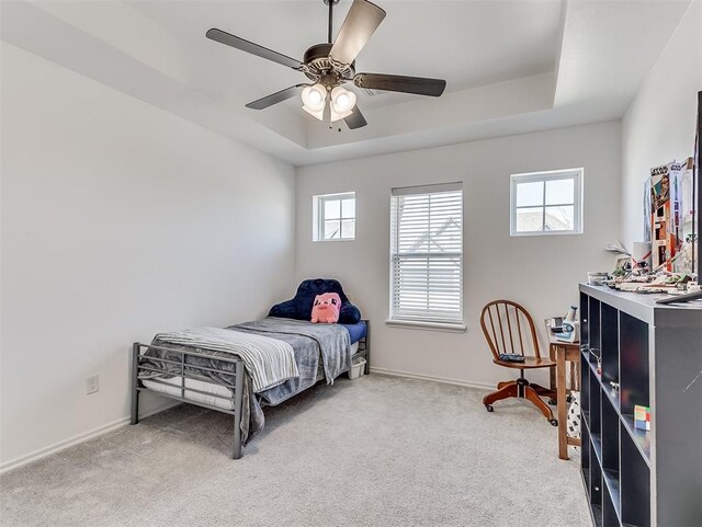 114 Alamosa Rd, Norman, OK 73069 - carpeted bedroom with multiple windows, baseboards, ceiling fan, and a raised ceiling