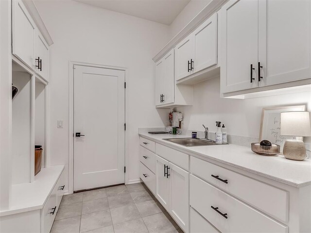 114 Alamosa Rd, Norman, OK 73069 - kitchen with a sink, white cabinets, light countertops, and light tile patterned floors