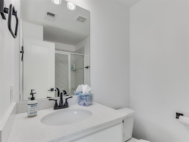 114 Alamosa Rd, Norman, OK 73069 - bathroom featuring a stall shower, toilet, and vanity